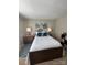 Bedroom with a full-sized bed with a white quilted cover and an art piece hanging over the bed at 303 Heritage Pkwy, Fort Mill, SC 29715