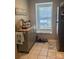 Bright kitchen with tile floors, stainless steel appliances, and natural light from window at 303 Heritage Pkwy, Fort Mill, SC 29715