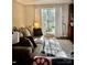 Living room showcasing a cozy sofa, large window, and sunlit interior at 303 Heritage Pkwy, Fort Mill, SC 29715