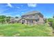 Spacious backyard featuring a covered patio, lush green lawn, and a wrought iron fence at 305 Decanting Ln, Fort Mill, SC 29707