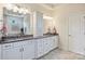 Bright bathroom featuring double vanity with granite countertops and white cabinetry at 305 Decanting Ln, Fort Mill, SC 29707