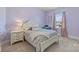 Charming bedroom with lilac walls, decorative bed, and a window with soft curtains at 305 Decanting Ln, Fort Mill, SC 29707
