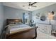 Comfortable bedroom with a wooden bed, blue walls, and a window view at 305 Decanting Ln, Fort Mill, SC 29707
