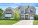 Charming brick home boasts beautiful landscaping, manicured lawn, and a welcoming driveway at 305 Decanting Ln, Fort Mill, SC 29707