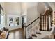 Bright foyer showcases staircase, complemented by natural light streaming through the front doors at 305 Decanting Ln, Fort Mill, SC 29707