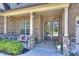 Inviting front porch with seating, double doors, and decorative wreaths welcomes visitors at 305 Decanting Ln, Fort Mill, SC 29707
