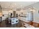 Modern white kitchen with island, stainless steel appliances, and breakfast area at 305 Decanting Ln, Fort Mill, SC 29707
