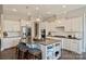 Kitchen island with granite countertop, white cabinets, and seating for guests at 305 Decanting Ln, Fort Mill, SC 29707