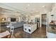 Open kitchen and living area with modern fixtures, island, and ample cabinet space at 305 Decanting Ln, Fort Mill, SC 29707