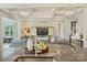Bright living room with coffered ceilings, modern lighting and a large television for entertaining at 305 Decanting Ln, Fort Mill, SC 29707