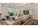Spacious living room featuring coffered ceilings, hardwood floors, and bar, perfect for entertaining at 305 Decanting Ln, Fort Mill, SC 29707
