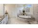 Luxurious main bathroom with soaking tub and double vanity with granite countertops at 305 Decanting Ln, Fort Mill, SC 29707