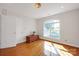 Well-lit bedroom featuring hardwood floors, a large window, and white walls at 3610 Providence Mill Rd, Maiden, NC 28650