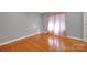 Spacious bedroom featuring gleaming hardwood floors and a sunny window at 3610 Providence Mill Rd, Maiden, NC 28650