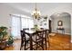 Charming dining room with ample natural light, hardwood floors, and elegant chandelier above at 3610 Providence Mill Rd, Maiden, NC 28650
