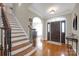 Welcoming foyer with hardwood floors, staircase, and arched doorway, creating a grand entrance at 3610 Providence Mill Rd, Maiden, NC 28650
