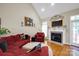Bright living room featuring a fireplace, hardwood floors, and comfortable seating arrangement at 3610 Providence Mill Rd, Maiden, NC 28650
