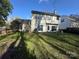 Lush backyard with vibrant green grass, mature trees, and a glimpse of the home's exterior at 3898 Longwood Sw Dr, Concord, NC 28027