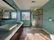 Modern bathroom with dual sinks, marble countertop, a glass-enclosed shower, and tiled flooring at 3898 Longwood Sw Dr, Concord, NC 28027