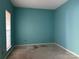 This empty bedroom features teal walls and a window with a window shade at 3898 Longwood Sw Dr, Concord, NC 28027