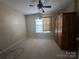Bedroom featuring a ceiling fan, window, and wardrobe for storage and comfortable living at 3898 Longwood Sw Dr, Concord, NC 28027