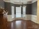 Spacious dining room featuring wood floors, large bay window, and elegant chandelier, ideal for Gathering gatherings at 3898 Longwood Sw Dr, Concord, NC 28027