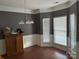 Formal dining room featuring wood floors, decorative wainscoting, and a modern chandelier at 3898 Longwood Sw Dr, Concord, NC 28027