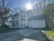 Bright two story home featuring an attached two car garage and well-manicured lawn at 3898 Longwood Sw Dr, Concord, NC 28027
