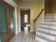 Inviting foyer with tile flooring, staircase, and glass paneled doors, creating a welcoming entrance at 3898 Longwood Sw Dr, Concord, NC 28027