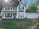 Charming two-story home with a well-maintained lawn, attached garage, and inviting front entrance at 3898 Longwood Sw Dr, Concord, NC 28027