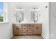 Bathroom featuring double sinks, wood cabinets, white countertops, and modern fixtures at 424 Airline Ave, Shelby, NC 28150