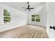 Bright bedroom with a modern ceiling fan and natural light from two windows at 424 Airline Ave, Shelby, NC 28150