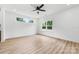 Bright bedroom with modern ceiling fan, light hardwood floors, and natural light from two windows at 424 Airline Ave, Shelby, NC 28150
