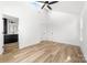 Bright bedroom featuring wood-look floors, skylight, ceiling fan, and adjoining bathroom at 424 Airline Ave, Shelby, NC 28150