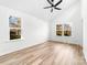 Light-filled bedroom with wood-look floors, ceiling fan, and large windows with natural light at 424 Airline Ave, Shelby, NC 28150