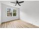 Well-lit bedroom with hardwood flooring, ceiling fan, and window at 424 Airline Ave, Shelby, NC 28150