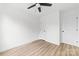 Bright bedroom with light hardwood floors, white walls, ceiling fan and two white doors at 424 Airline Ave, Shelby, NC 28150