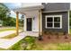The front porch features wooden support columns and a black front door, enhancing the home's curb appeal at 424 Airline Ave, Shelby, NC 28150
