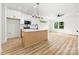 Bright, open-concept kitchen with island, pendant lights, white cabinets, and stainless steel appliances at 424 Airline Ave, Shelby, NC 28150