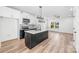 Spacious, open kitchen with modern finishes, a kitchen island, stainless appliances, and hardwood flooring at 424 Airline Ave, Shelby, NC 28150