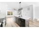 Modern kitchen featuring an island with quartz countertops, a stainless sink, and modern appliances at 424 Airline Ave, Shelby, NC 28150