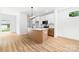 Open-concept kitchen with an island, pendant lighting, white cabinets, and stainless steel appliances at 424 Airline Ave, Shelby, NC 28150