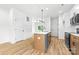 Kitchen island with sink, modern faucet, natural wood cabinets and stainless steel dishwasher at 424 Airline Ave, Shelby, NC 28150