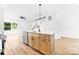 Kitchen island with sink, stainless steel dishwasher, and natural wood cabinets and modern hardware at 424 Airline Ave, Shelby, NC 28150