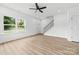 Bright living room with stairwell and luxury vinyl flooring and a large window at 424 Airline Ave, Shelby, NC 28150