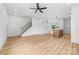 Bright living room with stairwell and luxury vinyl flooring, leading to an open-concept kitchen at 424 Airline Ave, Shelby, NC 28150