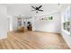 Open-concept living room and kitchen featuring modern white cabinets, island, and luxury vinyl flooring at 424 Airline Ave, Shelby, NC 28150