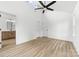 Bright main bedroom with a ceiling fan, light wood flooring, and a glimpse of an ensuite bath at 424 Airline Ave, Shelby, NC 28150