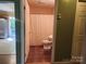 Bathroom with toilet and shower featuring neutral colors and tile floor at 4409 Homestead Rd, Rock Hill, SC 29732