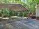 Spacious metal carport with an adjacent wooden deck and stairs leading to the home's backyard at 4409 Homestead Rd, Rock Hill, SC 29732